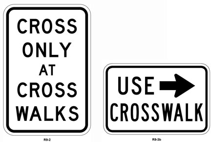 Figure 6 shows a sign that say “Cross Only at Crosswalks” and a sign that says “Use Crosswalk” and has an arrow pointing to the crosswalk.