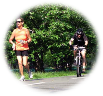 photo of a jogger and bicyclist on a shared use path